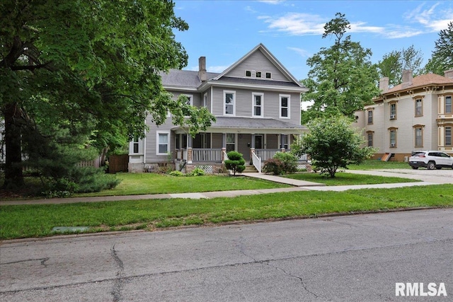 view of front of home featuring covered porch and a front yard