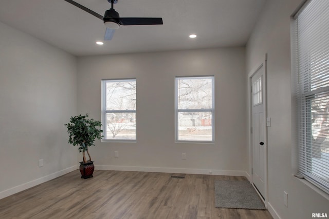 empty room featuring ceiling fan and light hardwood / wood-style flooring