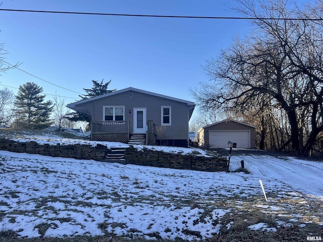 view of front property with a garage and an outbuilding