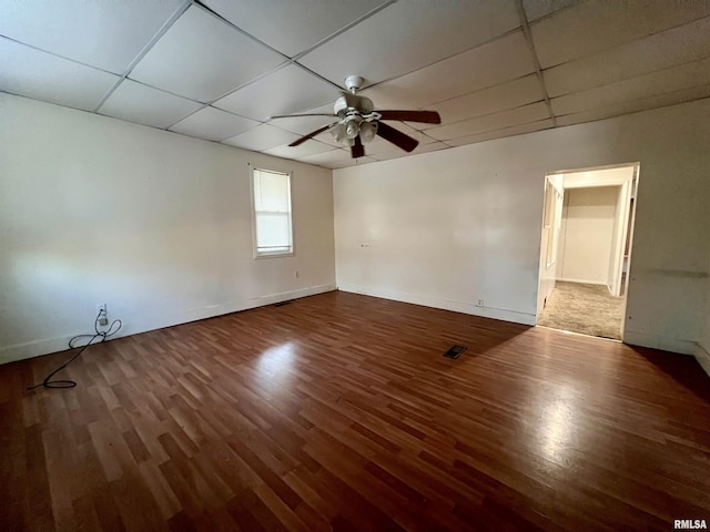 unfurnished room featuring ceiling fan, a drop ceiling, and hardwood / wood-style floors