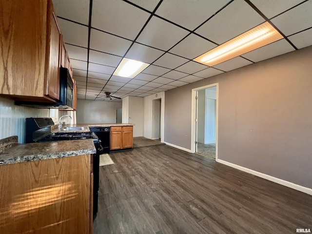 kitchen with black appliances, ceiling fan, and dark hardwood / wood-style floors