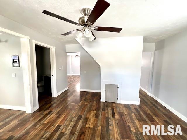 interior space featuring ceiling fan and dark hardwood / wood-style flooring