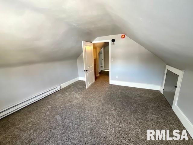 bonus room with lofted ceiling, a baseboard heating unit, and dark colored carpet