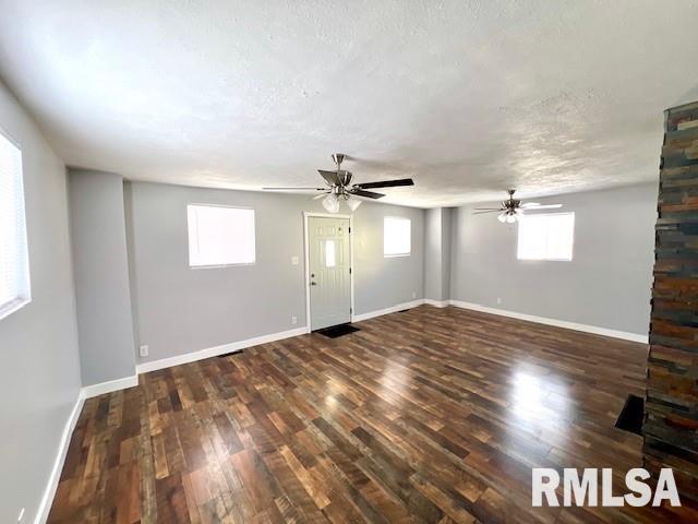 unfurnished room featuring a textured ceiling and dark hardwood / wood-style floors