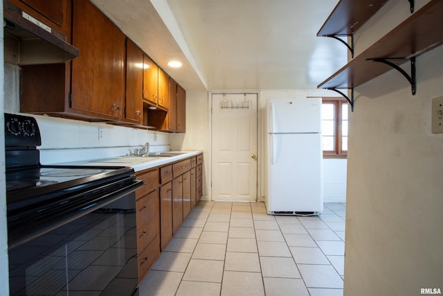 kitchen featuring sink, electric range, white fridge, and light tile patterned flooring