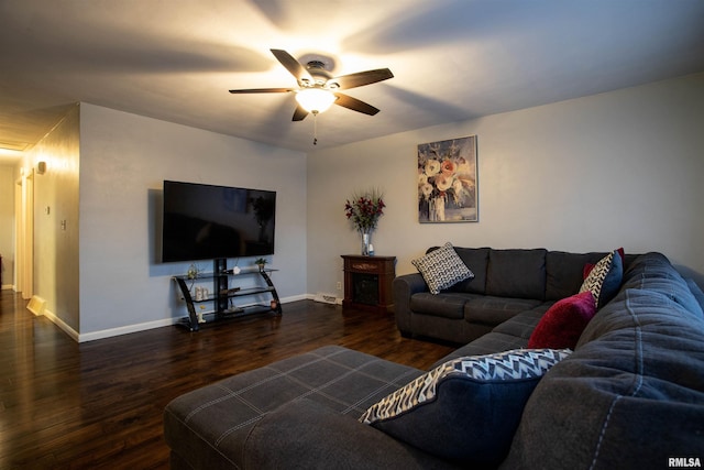 living room with ceiling fan and dark hardwood / wood-style floors