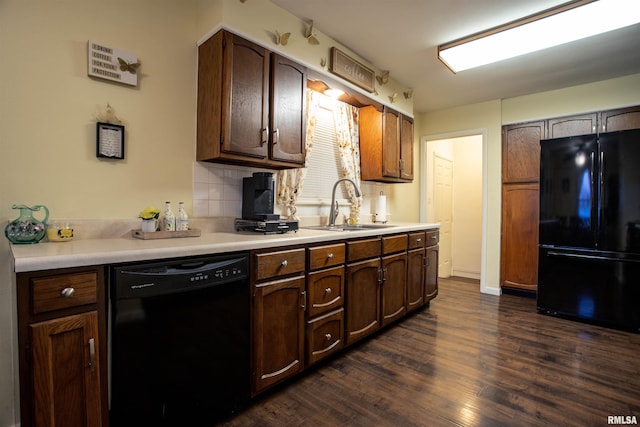 kitchen with tasteful backsplash, dark hardwood / wood-style floors, black appliances, sink, and dark brown cabinetry