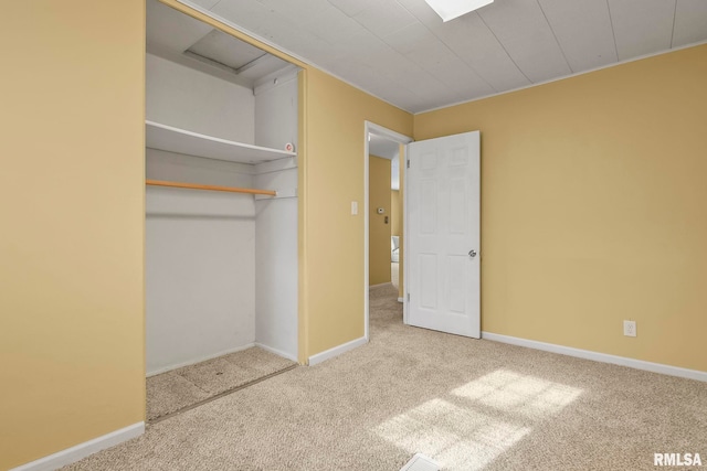 unfurnished bedroom featuring a closet, carpet flooring, and baseboards