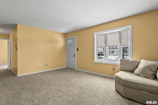 carpeted living area with baseboards