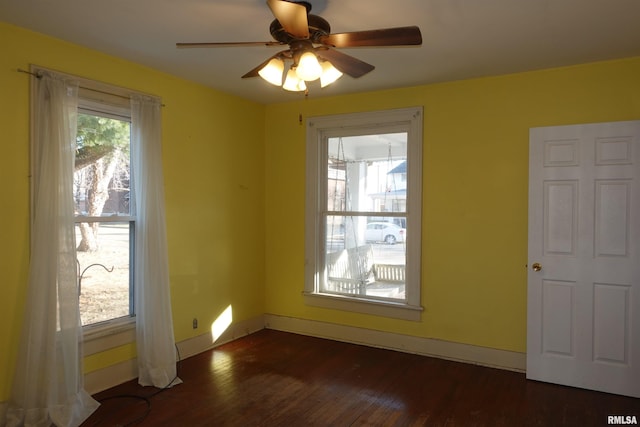 unfurnished room featuring ceiling fan and dark hardwood / wood-style flooring