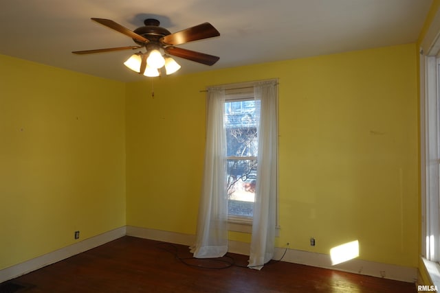 spare room with ceiling fan and dark wood-type flooring