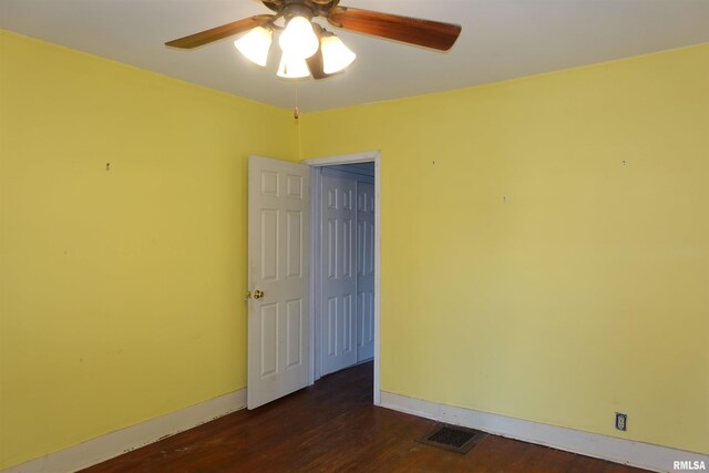 unfurnished room with ceiling fan and dark hardwood / wood-style flooring