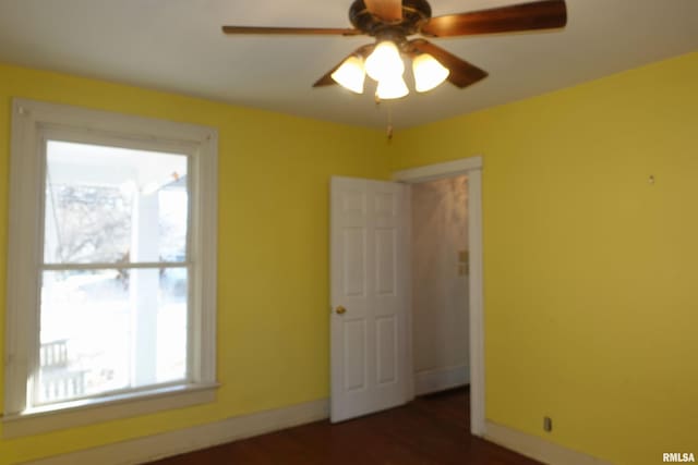 unfurnished room with ceiling fan and dark hardwood / wood-style floors