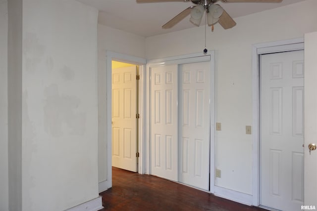 unfurnished bedroom featuring dark wood-type flooring and ceiling fan