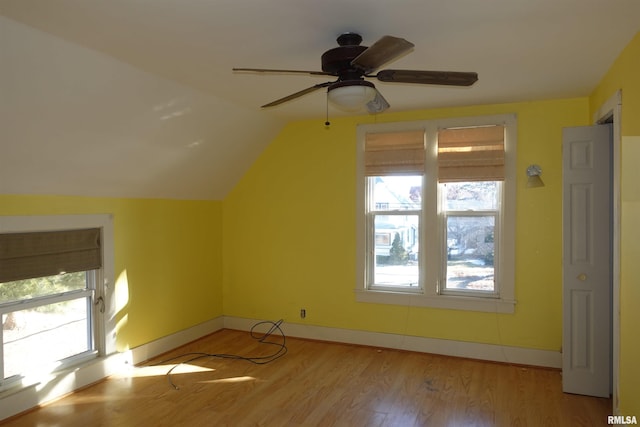 bonus room with light hardwood / wood-style floors, a healthy amount of sunlight, ceiling fan, and vaulted ceiling