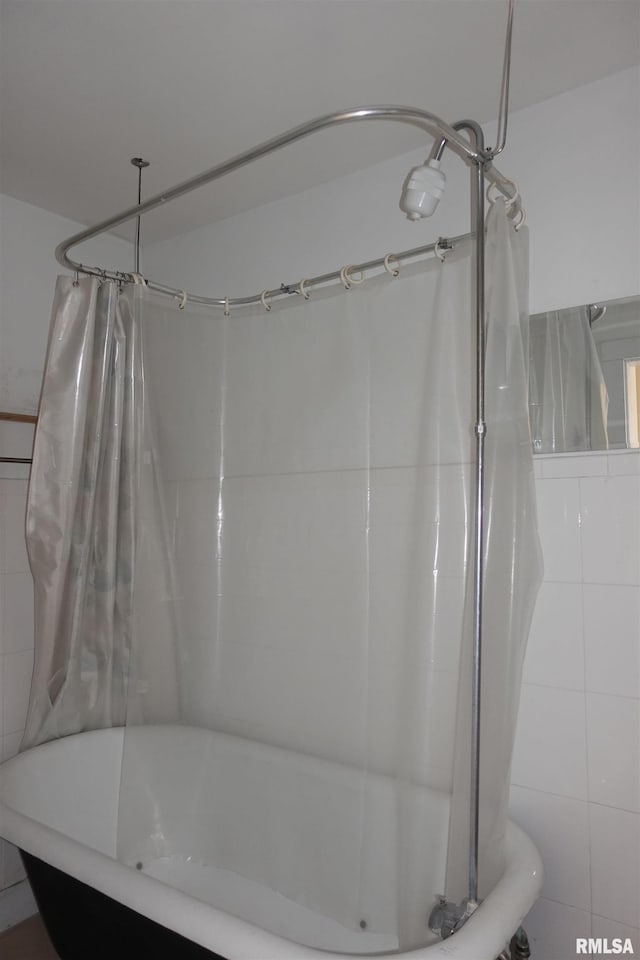 bathroom featuring tile walls and shower / bath combo