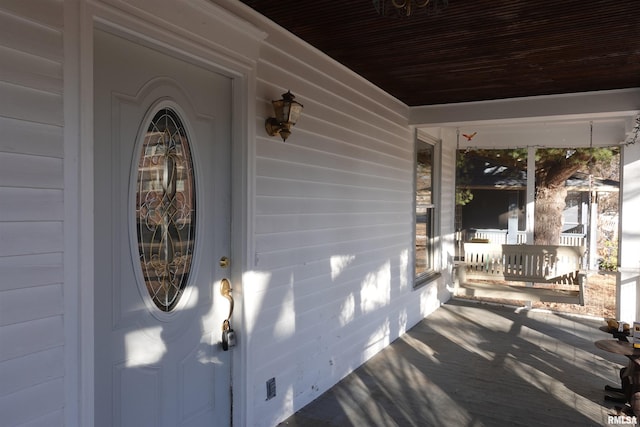 view of exterior entry with a porch