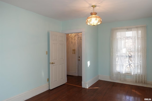 spare room with dark wood-type flooring