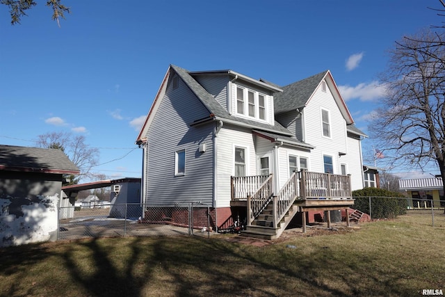 back of house with a deck and a yard