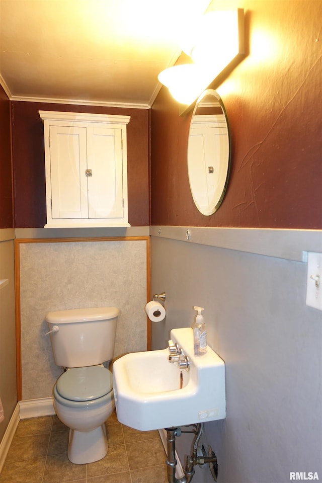 bathroom featuring sink, tile patterned floors, crown molding, and toilet