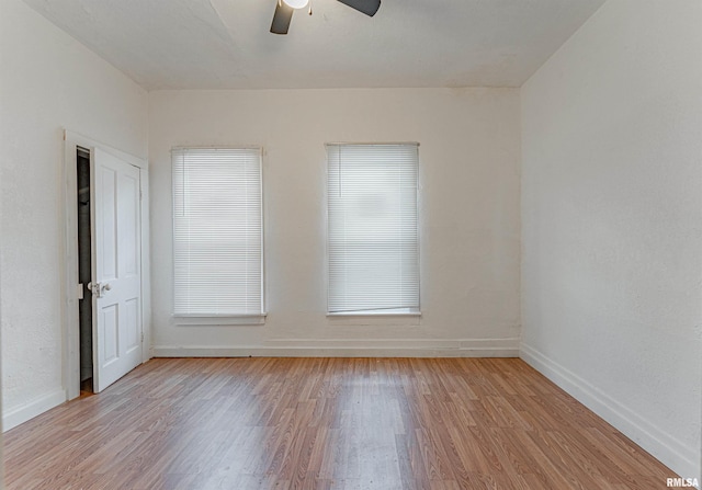 unfurnished room with ceiling fan and light wood-type flooring