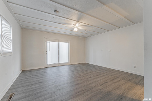 empty room featuring ceiling fan and hardwood / wood-style floors