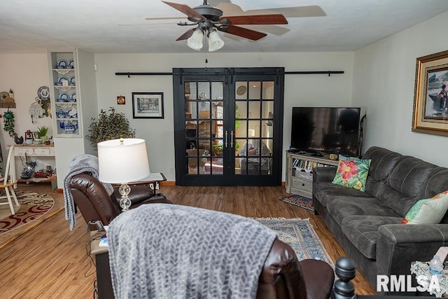 living room with wood-type flooring, ceiling fan, and french doors