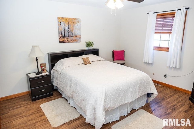 bedroom with dark wood-type flooring and ceiling fan