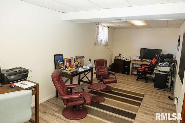 office area with hardwood / wood-style floors and a drop ceiling