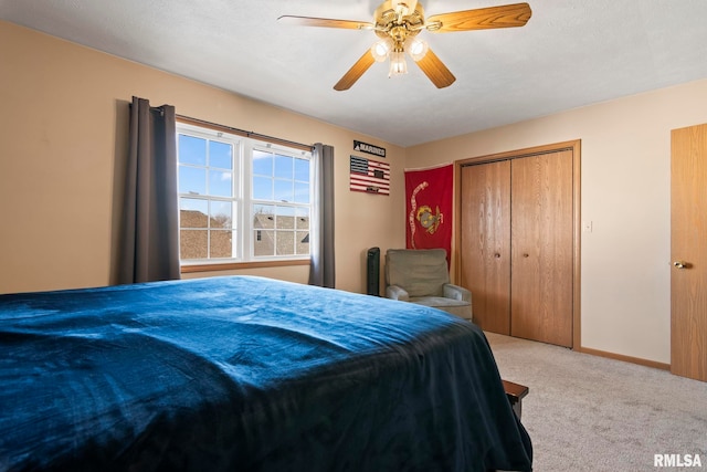 carpeted bedroom with a closet and ceiling fan