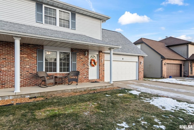 view of front facade featuring a garage and covered porch