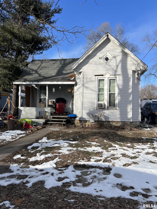 view of front of home with covered porch and cooling unit