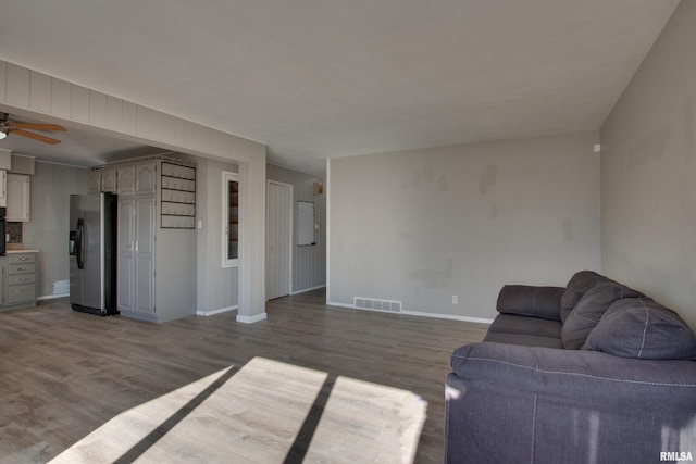 unfurnished living room with ceiling fan and hardwood / wood-style floors