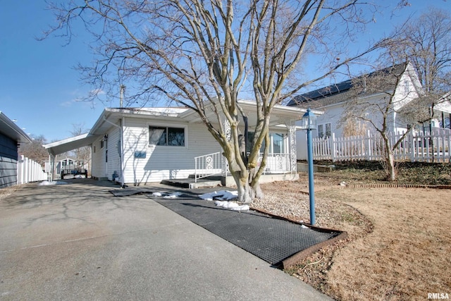 view of front of house featuring a porch and a carport