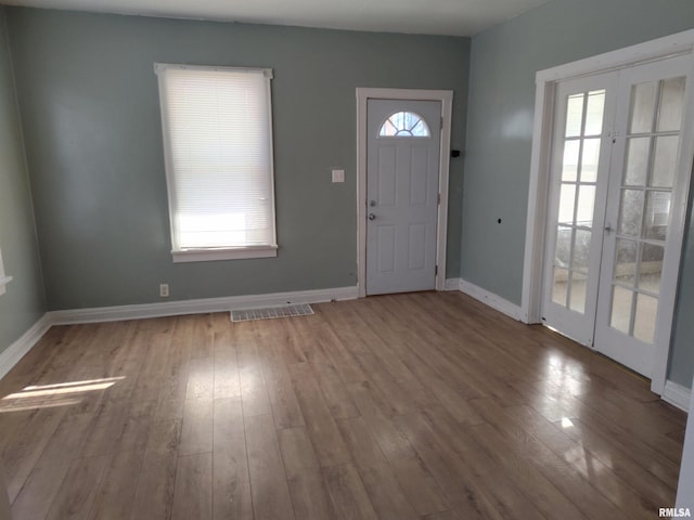 foyer with plenty of natural light and hardwood / wood-style floors