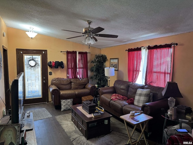 living room with ceiling fan, plenty of natural light, and a textured ceiling