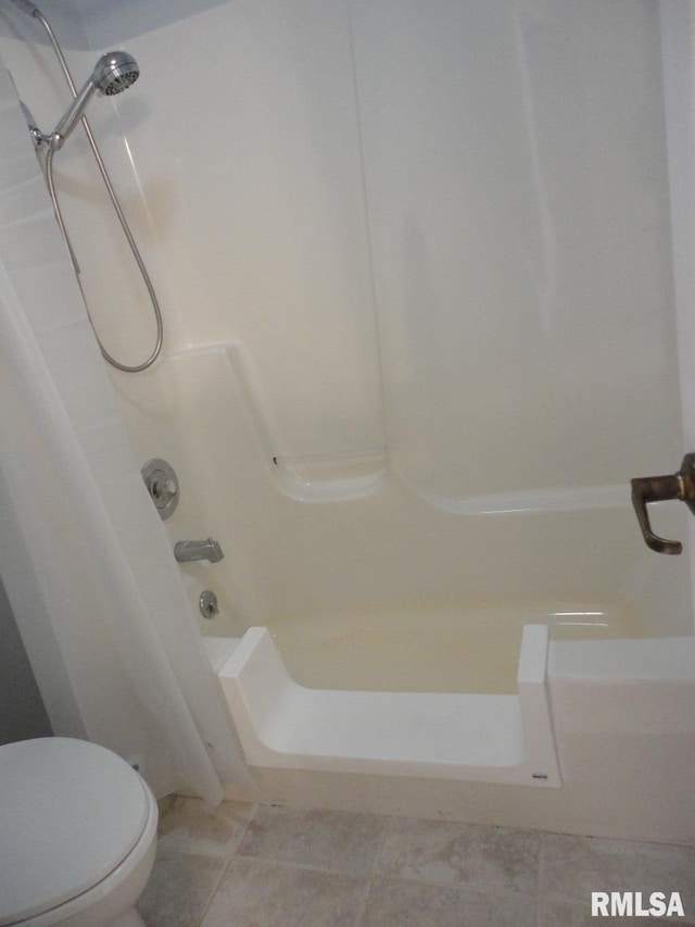 bathroom featuring shower / bathing tub combination, tile patterned floors, and toilet