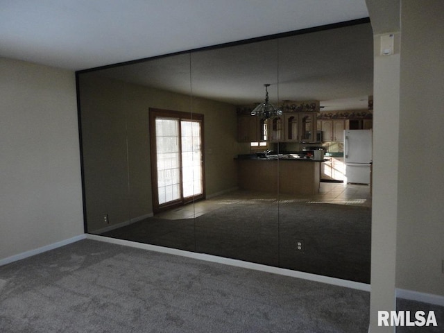 unfurnished dining area featuring light carpet