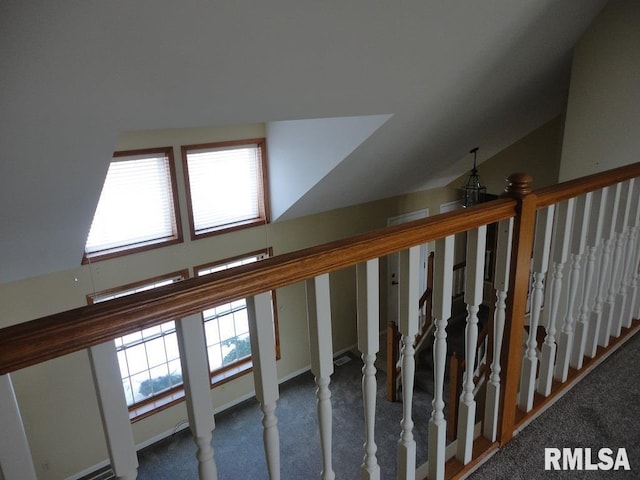 staircase featuring a wealth of natural light, carpet, and vaulted ceiling