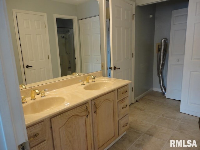 bathroom with vanity and a shower