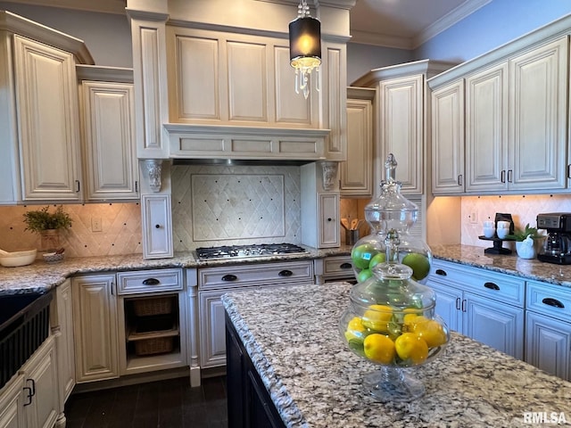 kitchen featuring hanging light fixtures, light stone countertops, and decorative backsplash