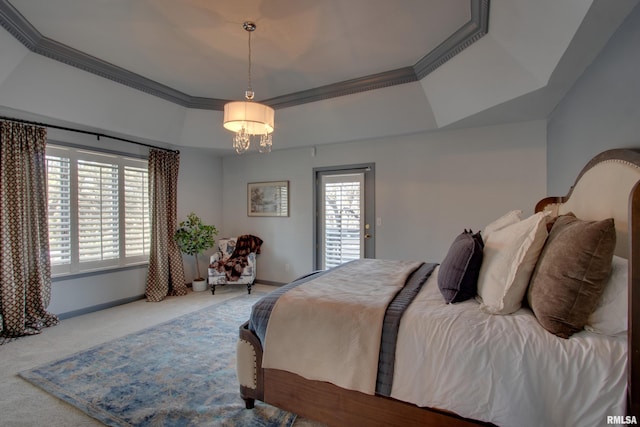 carpeted bedroom featuring crown molding, a raised ceiling, and a chandelier