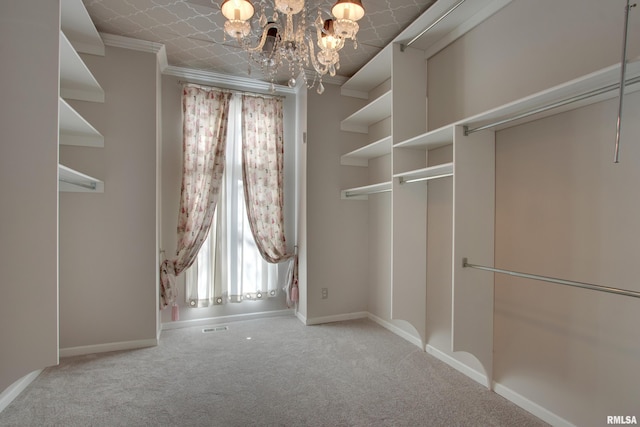 spacious closet featuring light carpet and a notable chandelier