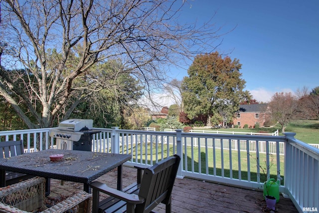 deck featuring area for grilling and a yard