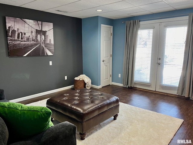 living area with dark hardwood / wood-style flooring and french doors