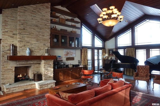 living room featuring a fireplace, wood-type flooring, french doors, high vaulted ceiling, and an inviting chandelier