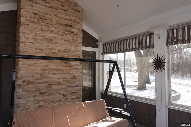 unfurnished sunroom featuring lofted ceiling