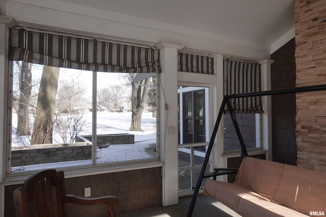 sunroom / solarium featuring vaulted ceiling