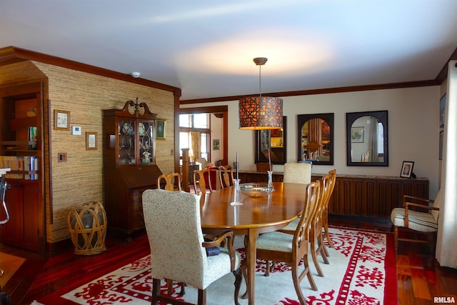 dining space with hardwood / wood-style flooring and ornamental molding