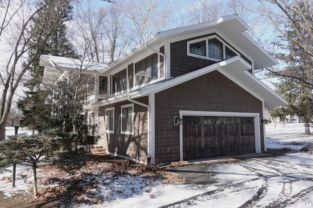 view of snowy exterior with a garage